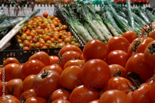 Wallpaper Mural Close-up of fresh red tomatoes and green scallions at a local market produce display. Torontodigital.ca