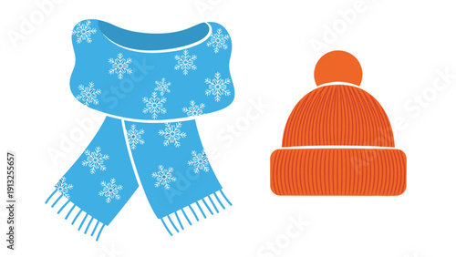 Blue winter scarf decorated with white snowflake patterns and an orange knit hat with a pompom on top against a white background.