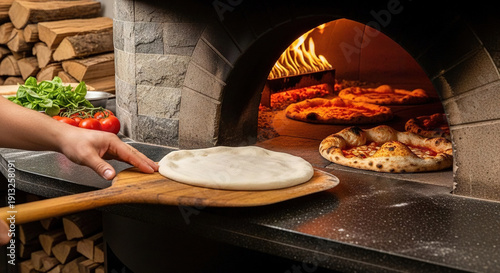 Chef placing dough into a wood-fired stone oven surrounded by fresh ingredients