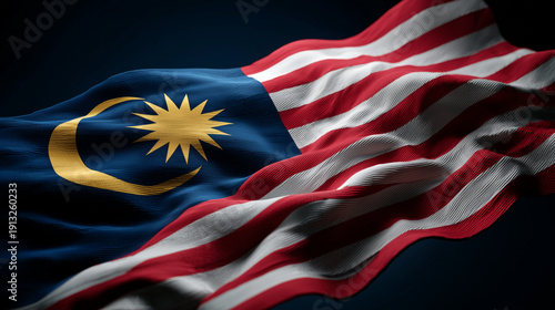 malaysian flag waving in the wind. flag of malaysia on dark black background
