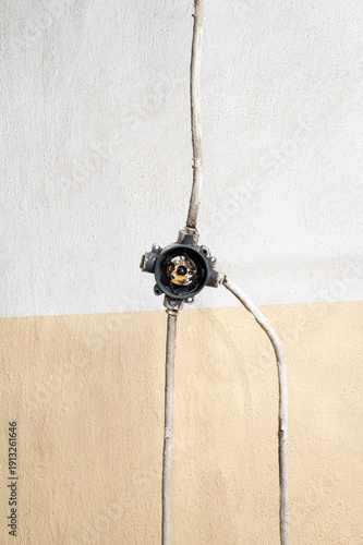 Open electrical junction box on wall with conduit