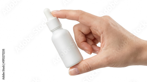 Obraz na plátně Close-up of a hand holding a small matte white essential oil or cosmetic dropper
