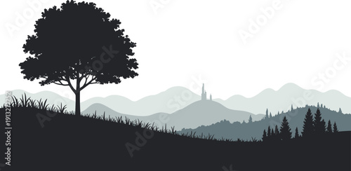 Silhouette of a lone tree on a hill with distant mountains