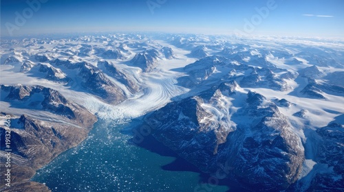 Wallpaper Mural Aerial view of a massive glacier flowing between snow-capped mountains into a deep blue fjord in the Arctic landscape Torontodigital.ca