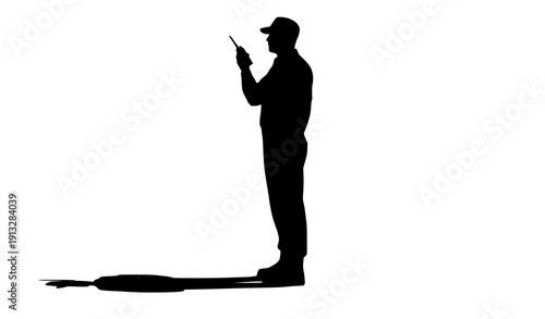 Silhouette of a Person with a Walkie-Talkie: A stark silhouette of a man holding a walkie-talkie, his profile cast against a bright, airy backdrop. This image embodies communication, industry.