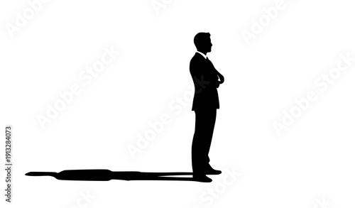 The Contemplative Silhouette: A solitary figure, a business person, stands confidently with arms crossed, their shadow a symbol of presence and introspection.