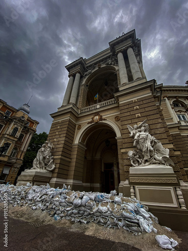 Odessa, Ukraine, February 10, 2026. Dramatic angle Odessa Opera House protected by sandbags against cloudy sky backdrop