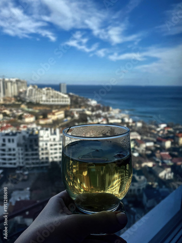Enjoying Refreshing Green Tea with Breathtaking Cityscape View from Balcony on Sunny Day, Perfect Moment of Relaxation and Serenity