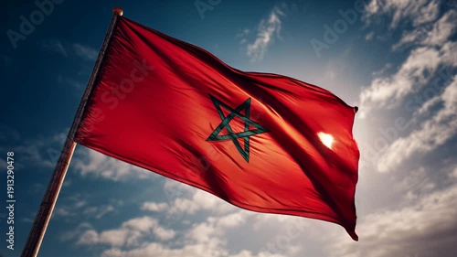 moroccan flag waving in blue sky. flag of morocco