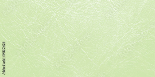 A vintage green grunge paper texture background with a light weathered canvas pattern and old parchment surface design for a blank textured backdrop