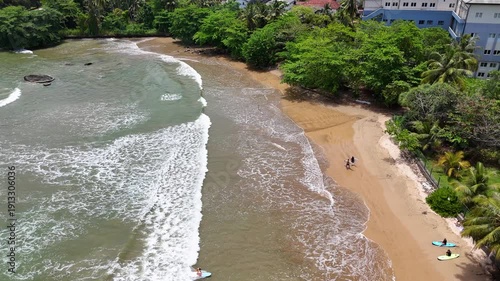 Galle, Sri Lanka, November 3, 2025: Devata Beach in the galle city and surfers riding in the waves