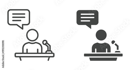 Person giving a speech at desk with a microphone and a chat bubble