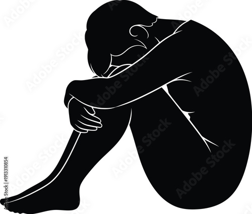 Distraught person sitting on the floor with their head on their knees