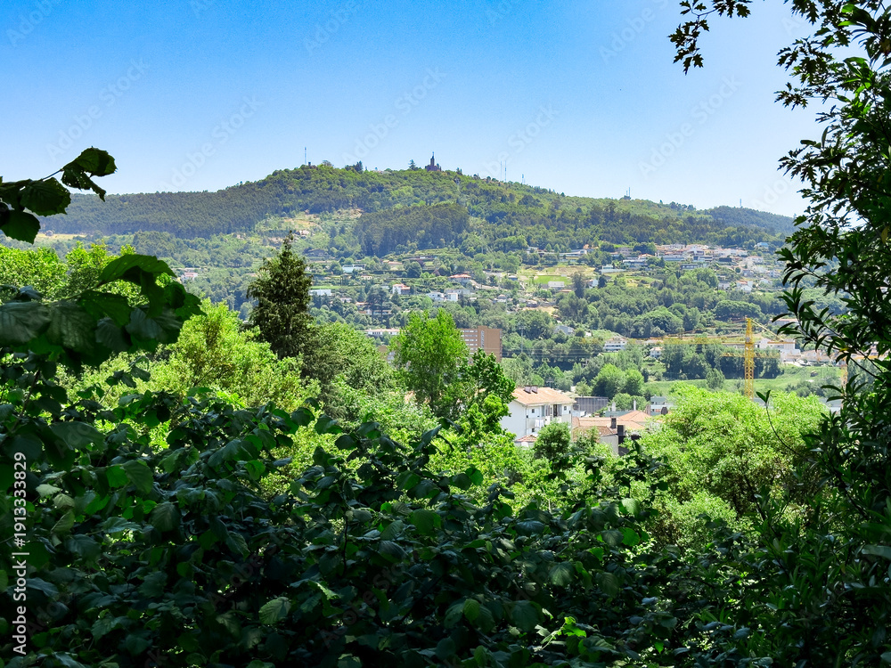 custom made wallpaper toronto digitalPanoramic view from Castle Hill in Guimaraes Portugal over green valley. Residential houses scattered across forested slopes under clear blue sky. Travel destination, scenic landscape,