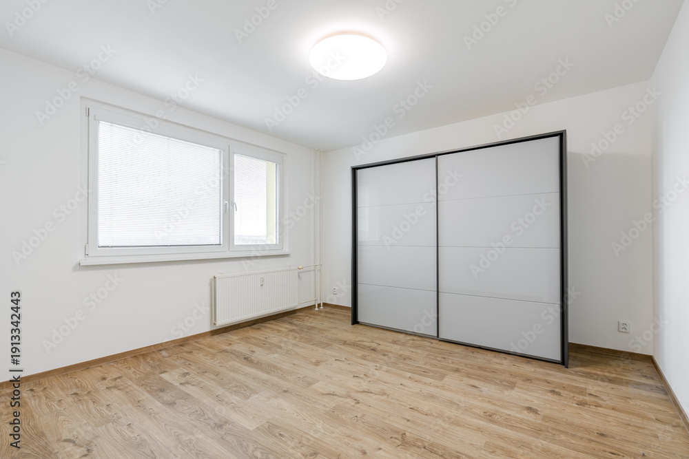 Fototapeta premium Empty modern apartment bedroom with sliding wardrobe and window