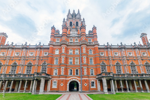 Victorian Red Brick University Building Facade On Historic Campus With Towers And Arches
