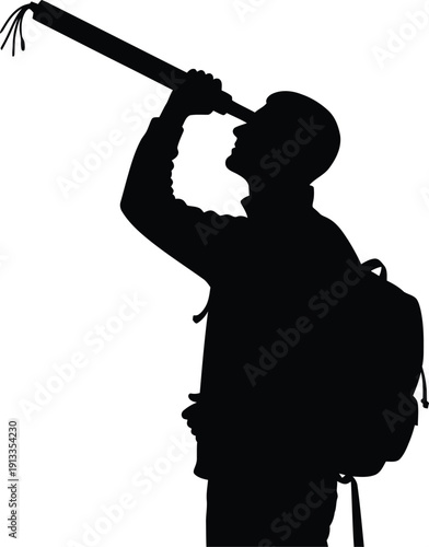 Silhouette of a man with a backpack looking through a telescope with great curiosity