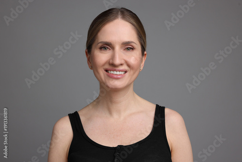 Portrait of beautiful woman on grey background