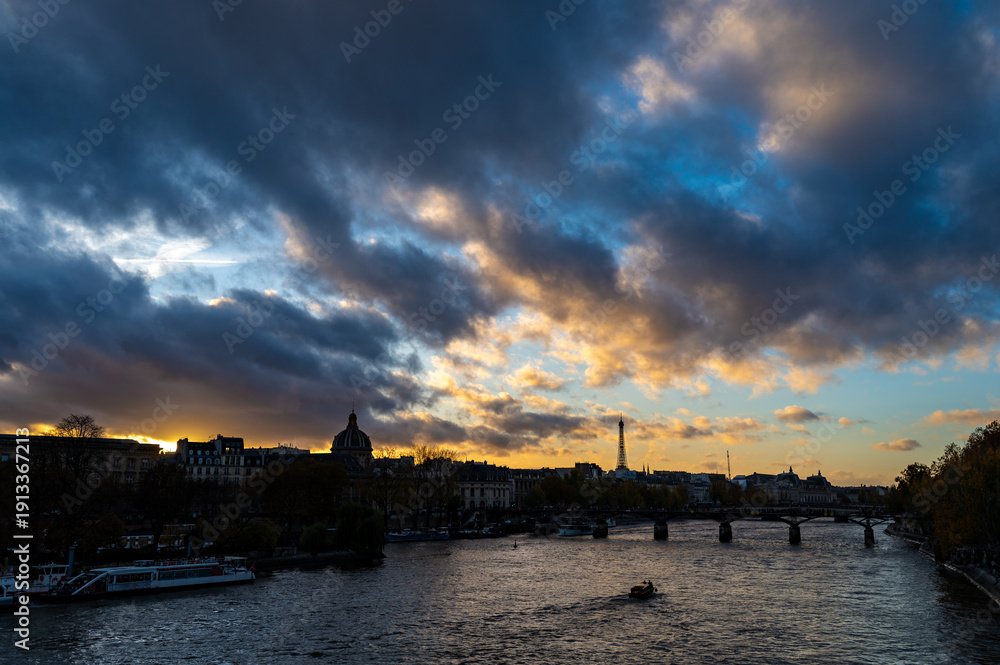 Fototapeta premium City views of Paris, streets, roands, buildings, Seine river on autumn evening tweenlight