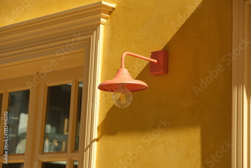 orange street lamp on a yellow wall