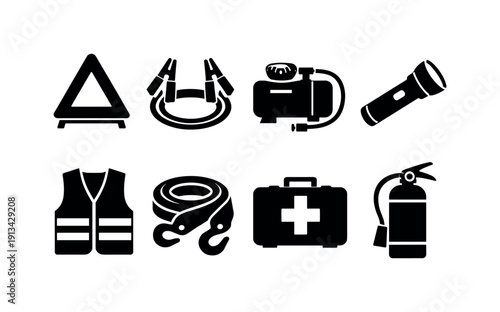 Outdoor car emergency gear: warning triangle, jumper cable, tire inflator, flashlight, safety vest, tow strap, first aid kit, fire extinguisher.
