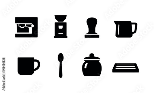 Kitchen coffee station items: espresso machine, coffee grinder, tamper, milk frothing pitcher, coffee mug, spoon, sugar jar, drip tray.