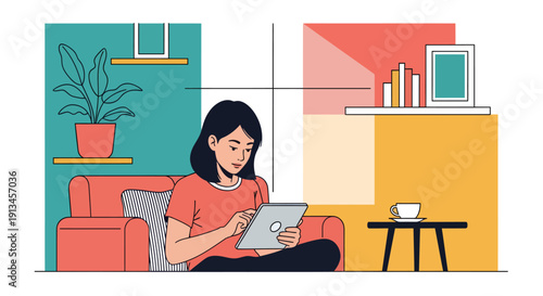 Young woman focused on tablet while relaxing on couch.