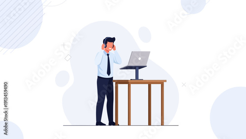 Businessman with headset working on laptop at standing desk, remote work concept