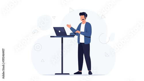 Man with headset and laptop at standing desk, online communication, remote work