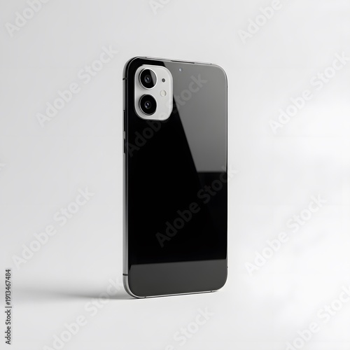 A sleek black phone case stands upright on a white surface, showcasing its reflective backside with dual camera lenses and subtle shadow underneath.