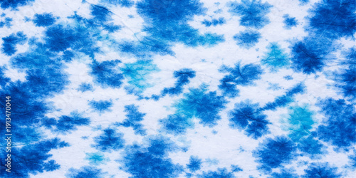 A bright and beautiful summer cloudscape features fluffy white clouds drifting across an abstract blue sky background illuminated by clear, sunny light in the vast atmosphere