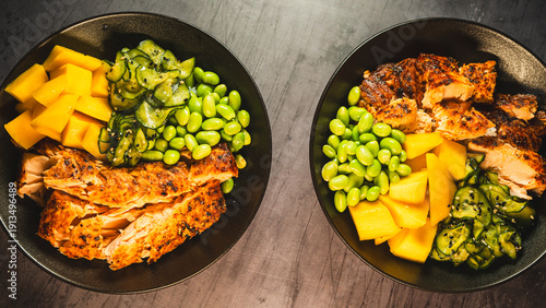 Photos Two beautiful poke bowls with golden grilled salmon, teriyaki glaze, edamame, crispy onions, sunomono, and cream cheese