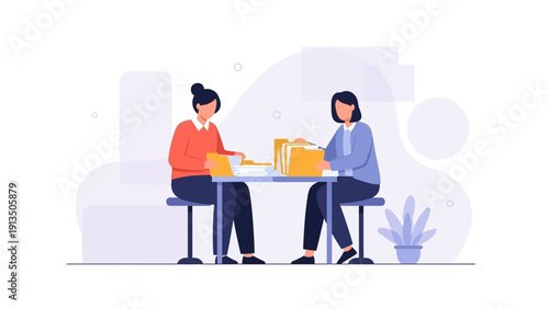 Two women reviewing documents and files at a table, business meeting, teamwork
