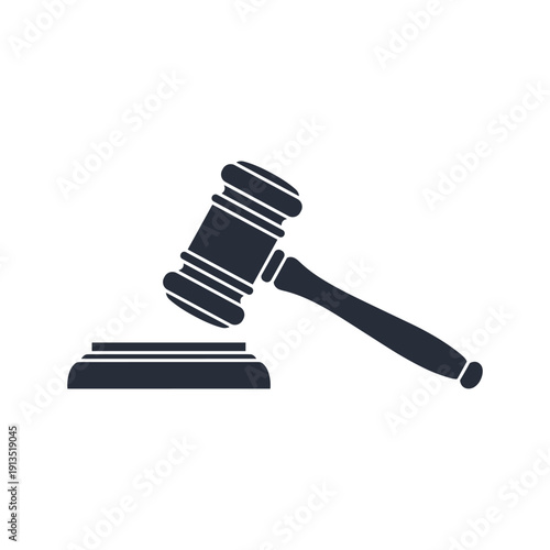 A gavel rests on a sound block in a courtroom setting