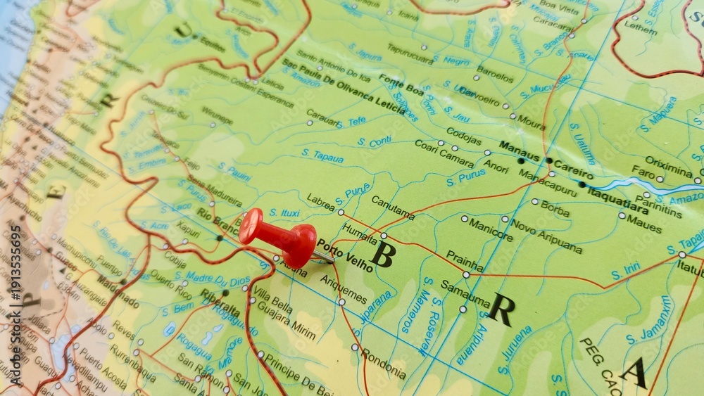 Fototapeta premium View of Porto Velho, is the capital of the Brazilian state of Rondonia, in the upper Amazon River basin, on a geographical map of America, marked with red push pin