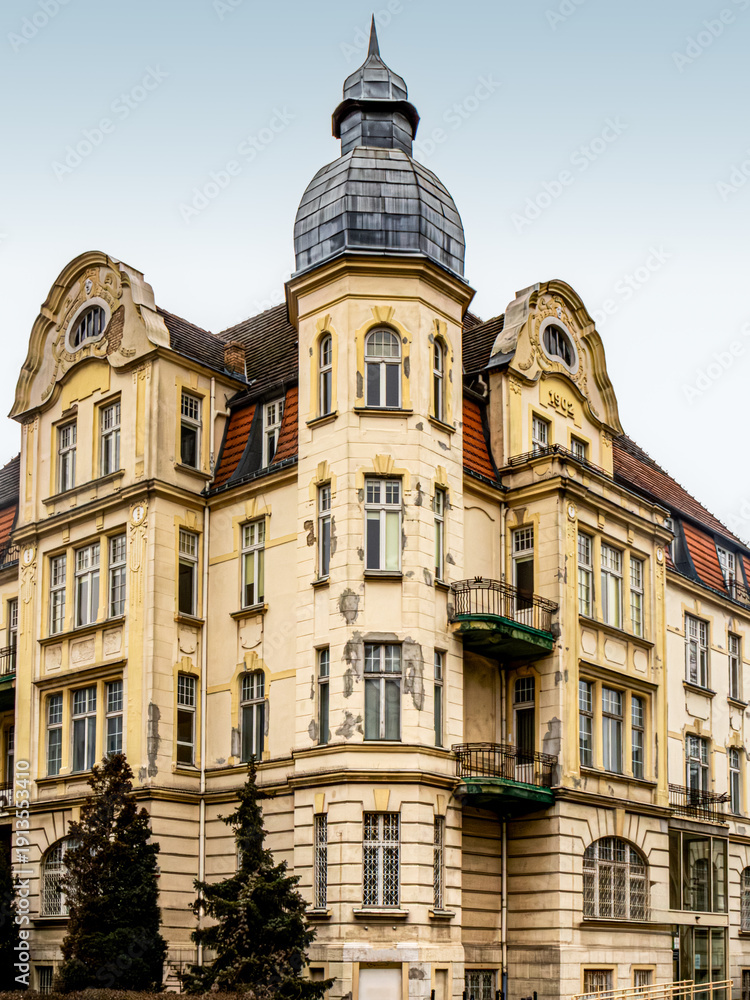 Fototapeta premium Historic European corner building with tower and balconies