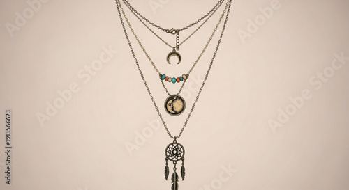 Dreamcatcher Necklaces Hanging on Chains against Beige Background