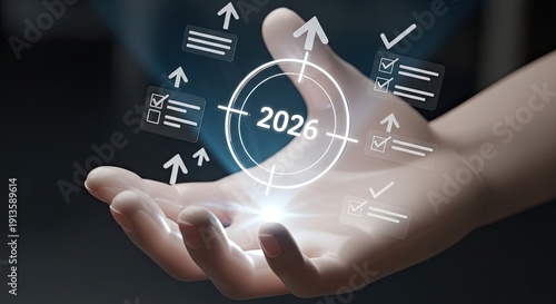 Hand holding a holographic projection of the year 2026 surrounded by business icons.