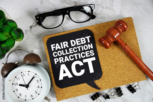 Fair Debt Collection Practices Act text on speech bubble with alarm clock and wooden gavel on marble background