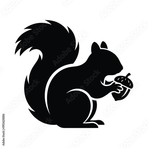 A black silhouette of a squirrel holding an acorn in its paws