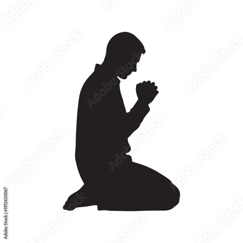 Silhouette of a man sitting on her knees praying. Side view on white back ground