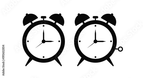 Two black alarm clocks display similar times as a striking silhouette