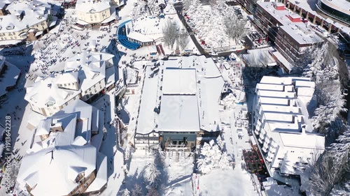Aerial 4K video from a drone to Sierra Nevada ski resort on a sunny winter day in the mountains, Spain. Sierra Nevada is the largest mountain range near the city of Granada in Spain with snow. Sierra 