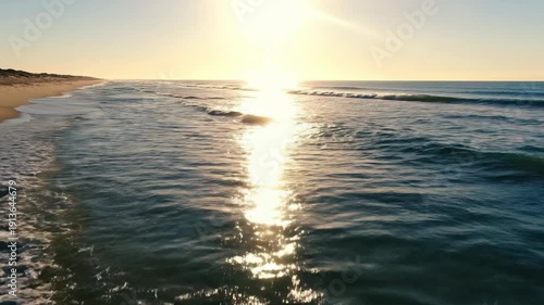 Serene Beach Scene with Gentle Waves at Sunset.