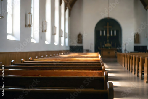 Serene interior of an old church with wooden pews and arched windows