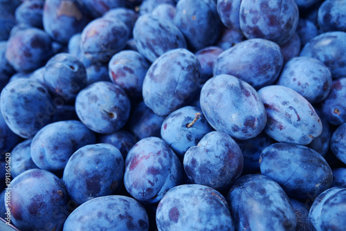Photography Fresh plums gathered together in a market setting