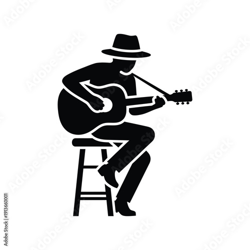 Musician playing guitar, sitting on stool, wearing hat, performing, folk music, concert