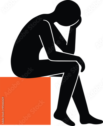 Man sitting sadly on orange block