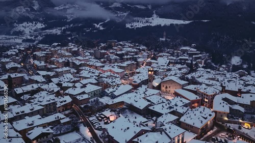 Snow-Covered Town Of Cavalese During Winter In The Val di Fiemme, Trentino Alto Adige, Italy. Aerial Pullback Shot