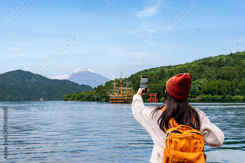Tableau sur toile Young happiness female tourist enjoying and taking photos of Mount Fuji and Hako